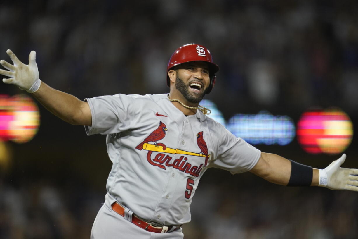 St. Louis Cardinals designated hitter Albert Pujols (5) watches after hitting a home run during the fourth inning of a baseball game against the Los Angeles Dodgers in Los Angeles, Friday, Sept. 23, 2022. Brendan Donovan and Tommy Edman also scored. It was Pujols' 700th career home run.