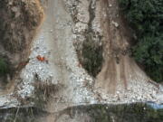 In this photo released by Xinhua News Agency, rescuers transfer an earthquake affected villager through a damaged mountain road near Moxi Town of Luding County, southwest China's Sichuan Province Wednesday, Sept. 7, 2022. The death toll in this week's earthquake in western China has jumped to more than dozen with plenty still missing, the government reported Wednesday, as frustration rose with uncompromising COVID-19 lockdown measures that prevented residents from leaving their buildings after the shaking.