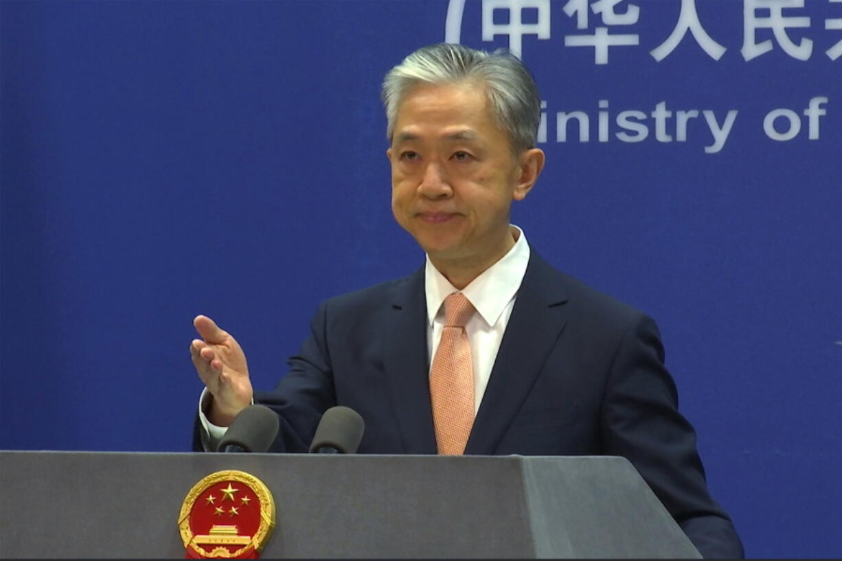 FILE - Chinese Foreign Ministry spokesperson Wang Wenbin reacts during the daily presser at the Ministry of Foreign Affiairs in Beijing, on May 27, 2022. After a U.N. report concluding that China's crackdown in the far west Xinjiang region may constitute crimes against humanity, China used a well-worn tactic to deflect criticism: blame a Western conspiracy.