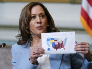 FILE - Vice President Kamala Harris displays a map showing abortion access by state as she speaks during the first meeting of the interagency Task Force on Reproductive Healthcare Access in the Indian Treaty Room in the Eisenhower Executive Office Building on the White House Campus in Washington, Aug. 3, 2022.