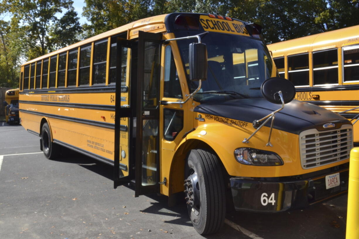 FILE - An electric school bus, leased by Beverly Public Schools in Beverly, Mass., rests in a bus yard, Oct. 21, 2021, in Beverly, Mass. The Environmental Protection Agency said Thursday, Sept. 29, that it will nearly double, to nearly $1 billion, funding available to states to acquire electric school buses, responding to what it calls overwhelming demand for cleaner school transportation.