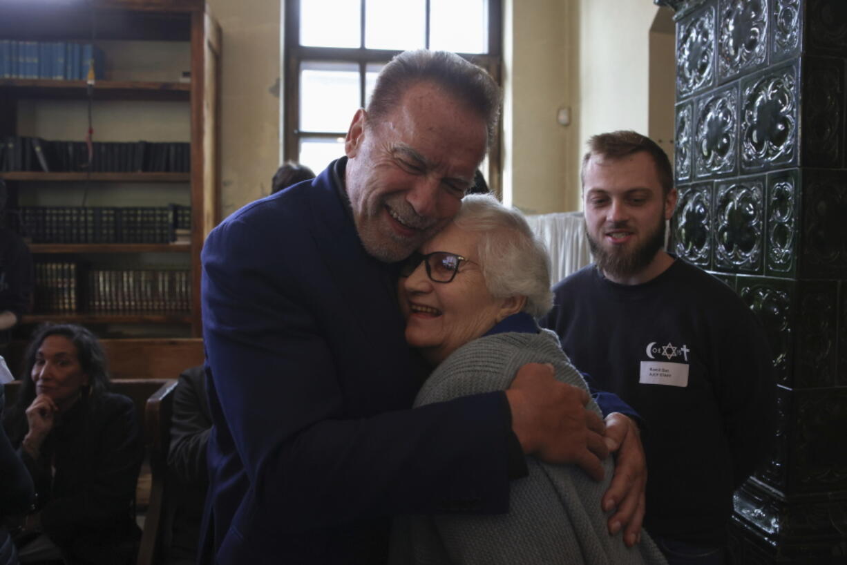 Arnold Schwarzenegger hugs Holocaust survivor Lydia Maksimovicz on Wednesday in Oswiecim, Poland, during a visit to  Auschwitz.