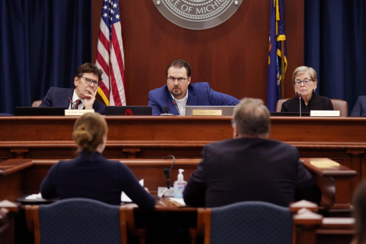 FILE - Members of the Michigan Board of State Canvassers, from left, Richard Houskamp, Anthony Daunt and Mary Ellen Gurewitz listen to attorneys Olivia Flower and Steve Liedel during a hearing, Wednesday, Aug. 31, 2022, in Lansing, Mich. Republican-dominated courts and legislatures have been pushing back against citizen-led ballot initiatives to keep them off the ballot, in what critics say is a partisan attack on direct democracy.