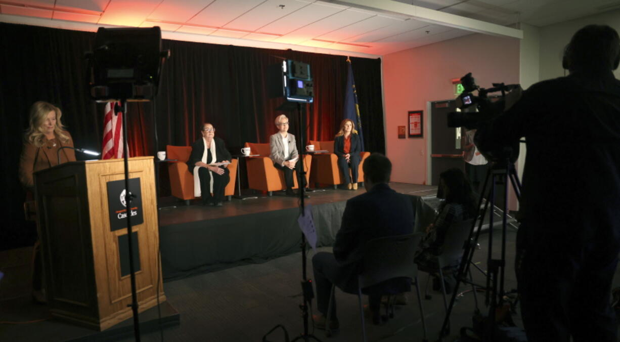 Oregon governor candidates, seated from left, Betsy Johnson, Tina Kotek and Christine Drazan prepare for a debate at Oregon State University- Cascades Tuesday, Sept. 27, 2022, in Bend, Ore.