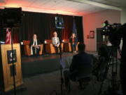 Oregon governor candidates, seated from left, Betsy Johnson, Tina Kotek and Christine Drazan prepare for a debate at Oregon State University- Cascades Tuesday, Sept. 27, 2022, in Bend, Ore.