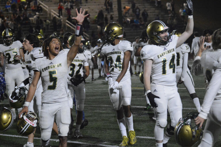 Evergreen’s Shaudez Gran (5) and Hayden Marcella waves to the Evergreen crowd after Evergreen’s 20-14 win over Mountain View at McKenzie Stadium on Friday, Sept. 30, 2022.