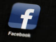 FILE - The Facebook logo is displayed on an iPad in Philadelphia, May 16, 2012. Facebook says it has identified and stopped a sprawling network of fake accounts that spread Russian propaganda about the invasion of Ukraine throughout Western Europe. Facebook parent company Meta says the network created 60 websites that mimicked legitimate news organizations but parroted Russian talking points about Ukraine.