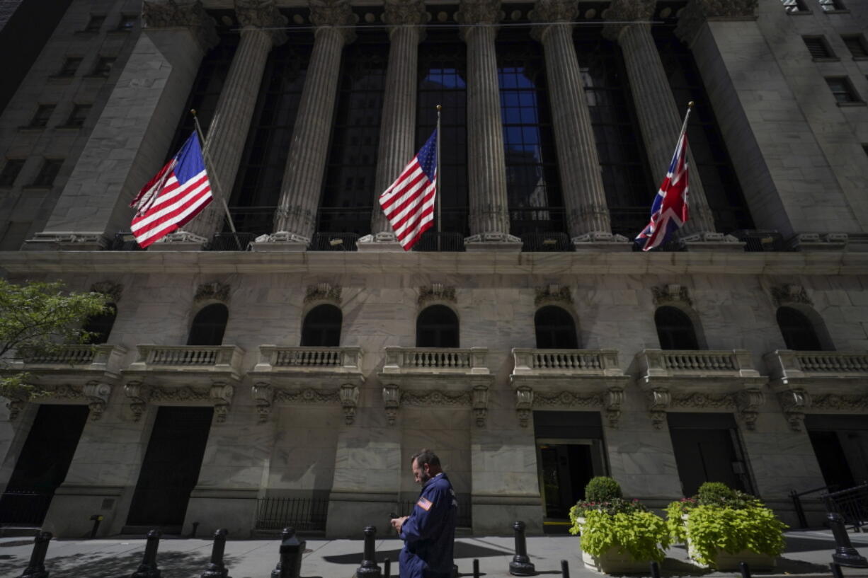 A trader looks over his cell phone outside the New York Stock Exchange, Wednesday, Sept. 14, 2022, in the financial district of Manhattan in New York.  Stocks are opening broadly lower on Wall Street, Friday, putting the market on track for another week of sizable losses, as a stark warning from FedEx about rapidly worsening trends in the economy gave investors more to worry about.