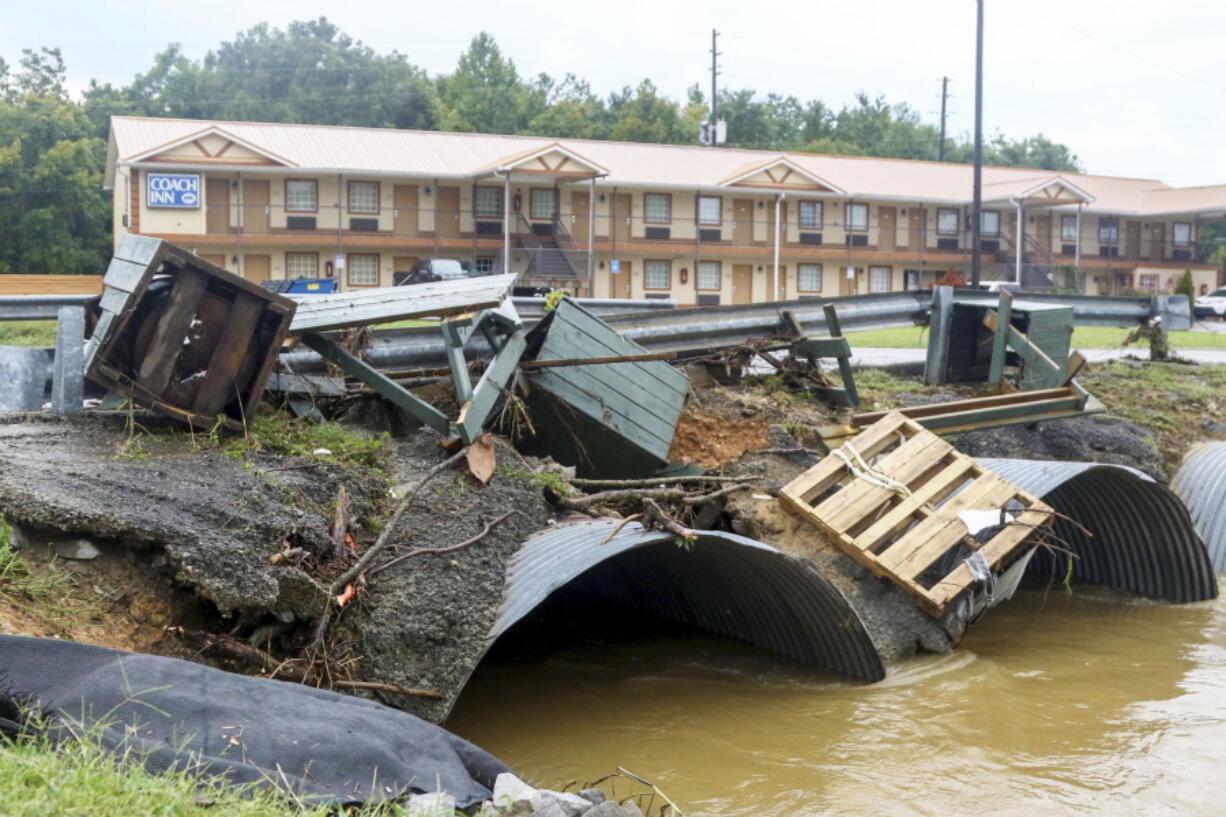 Trash cans from JR Dick Dowdy Park wash up outside of the Coach Inn Sunday, Sept. 4, 2022, in Summerville, Ga. After heavy rainfall, a Flash Flood Warning was issued in Summerville Sunday.