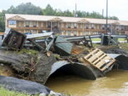 Trash cans from JR Dick Dowdy Park wash up outside of the Coach Inn Sunday, Sept. 4, 2022, in Summerville, Ga. After heavy rainfall, a Flash Flood Warning was issued in Summerville Sunday.