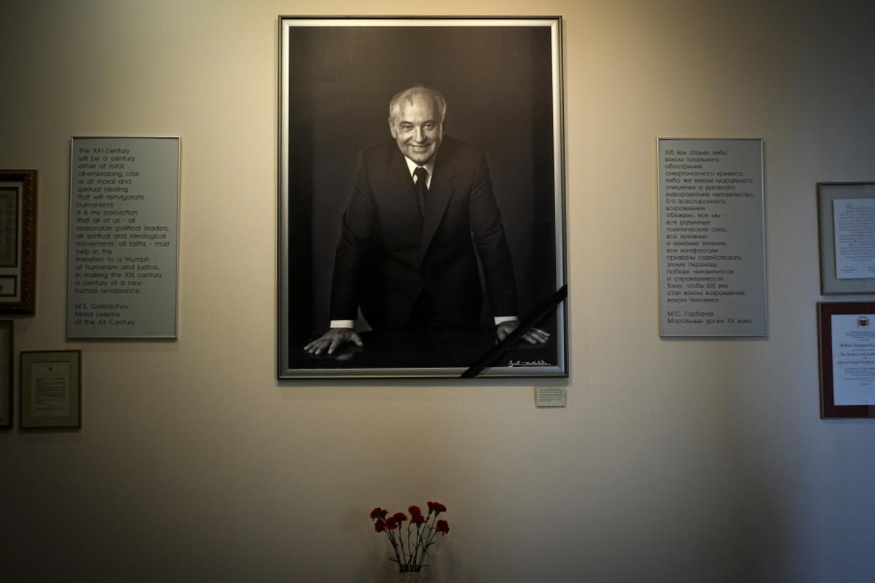 FILE - A portrait of the former Soviet President Mikhail Gorbachev and flowers are placed at his foundation's headquarters, a day after his passing, in Moscow, Russia, Wednesday, Aug. 31, 2022. The passing of Mikhail Gorbachev, the last leader of the Soviet Union and for many the man who restored democracy to then-communist-ruled European nations, was mourned Wednesday as the loss of a rare leader who changed the world and for a time gave hope for peace among the superpowers.