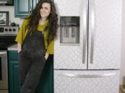 Designer Liz Morrow stands next to her refrigerator covered with a stylish patterned Tempaper removable paper at her home in Tacoma.