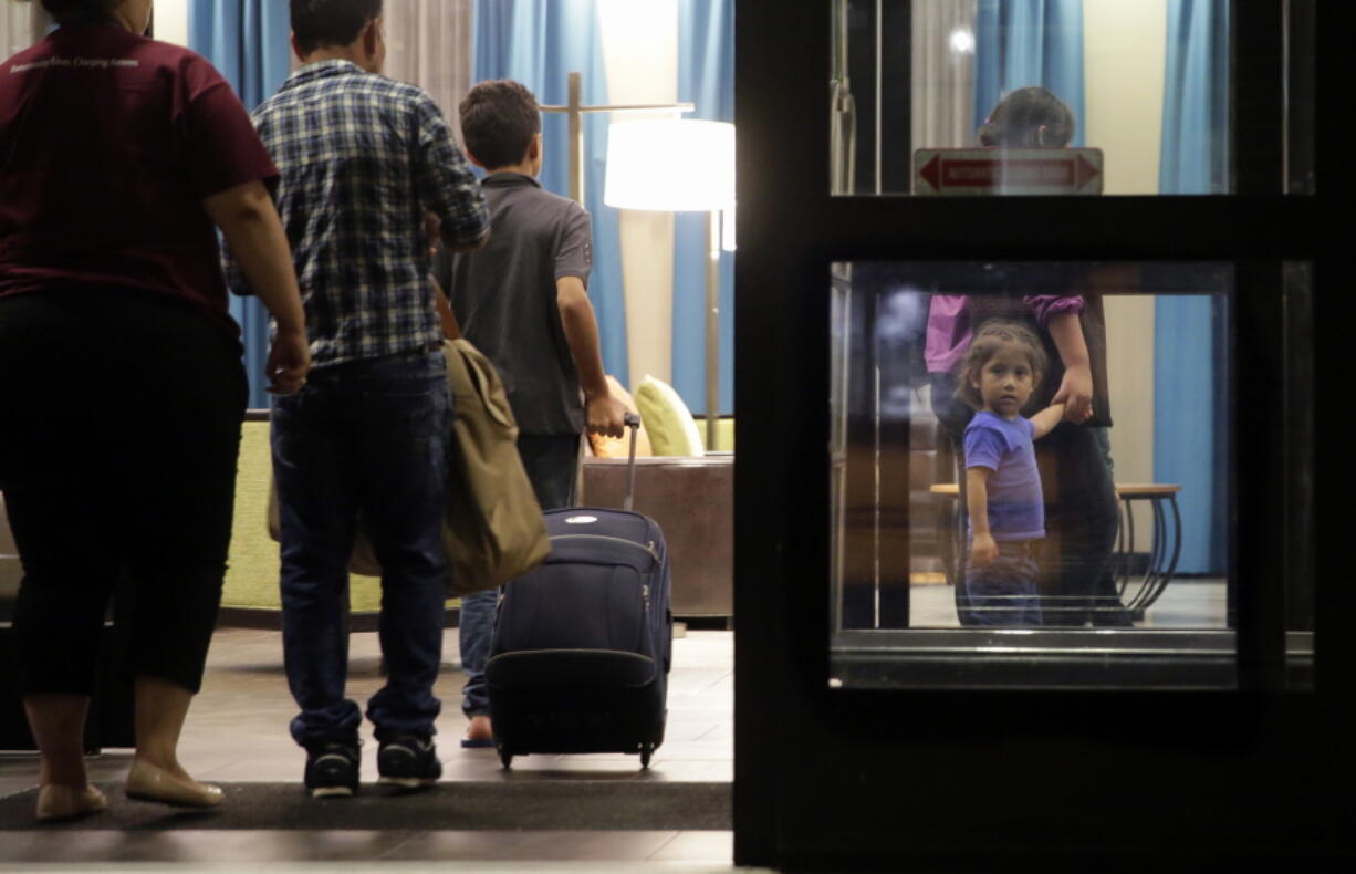 FILE - Immigrants seeking asylum who were recently reunited arrive at a hotel in San Antonio, July 23, 2018. The Biden administration is asking that parents of children separated at the U.S.-Mexico border undergo another round of psychological evaluations in an effort to measure how just traumatized they were by the Trump-era policy, court documents show.