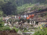 Rescuers conduct a search operation at the site of a landslide in Mimata, Miyazaki Prefecture, southern Japan, Monday Sept. 19, 2022. Powerful Typhoon Nanmadol slammed ashore in southern Japan on Sunday as it pounded the region with strong winds and heavy rain, causing blackouts, paralyzing ground and air transportation and prompting the evacuation of thousands of people.