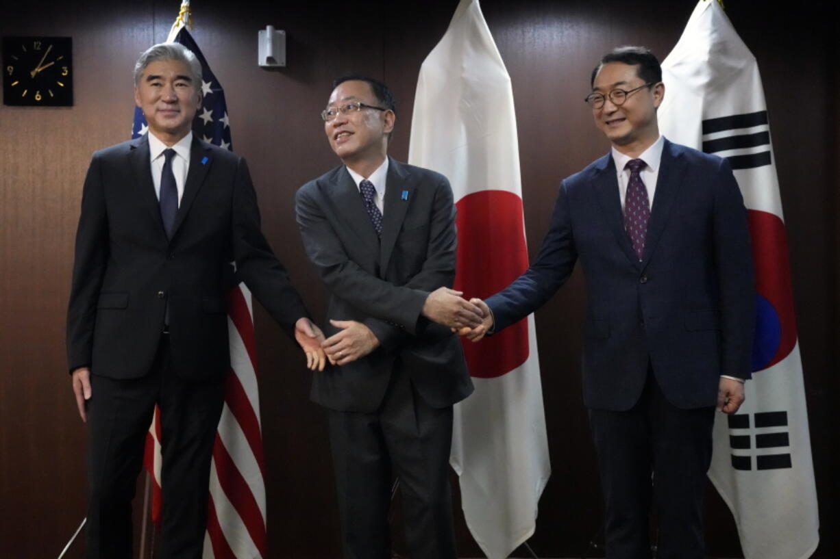 U.S. Special Representative for North Korea Sung Kim, left, Japan Director-General for Asian and Oceanian Affairs Bureau Takehiro Funakoshi, center, and South Korea Special Representative for Korean Peninsula Peace and Security Affairs Kim Gunn pose for media prior to their trilateral meeting on North Korea at the Ministry of Foreign Affairs of Japan Wednesday, Sept. 7, 2022, in Tokyo.