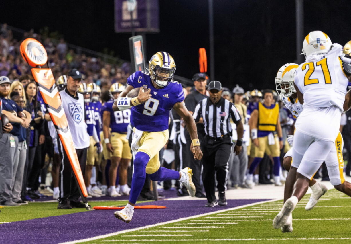 Washington's Michael Penix Jr. rushes to the Kent State 9-yard line during the second quarter of an NCAA college football game Saturday, Sept. 3, 2022, in Seattle.