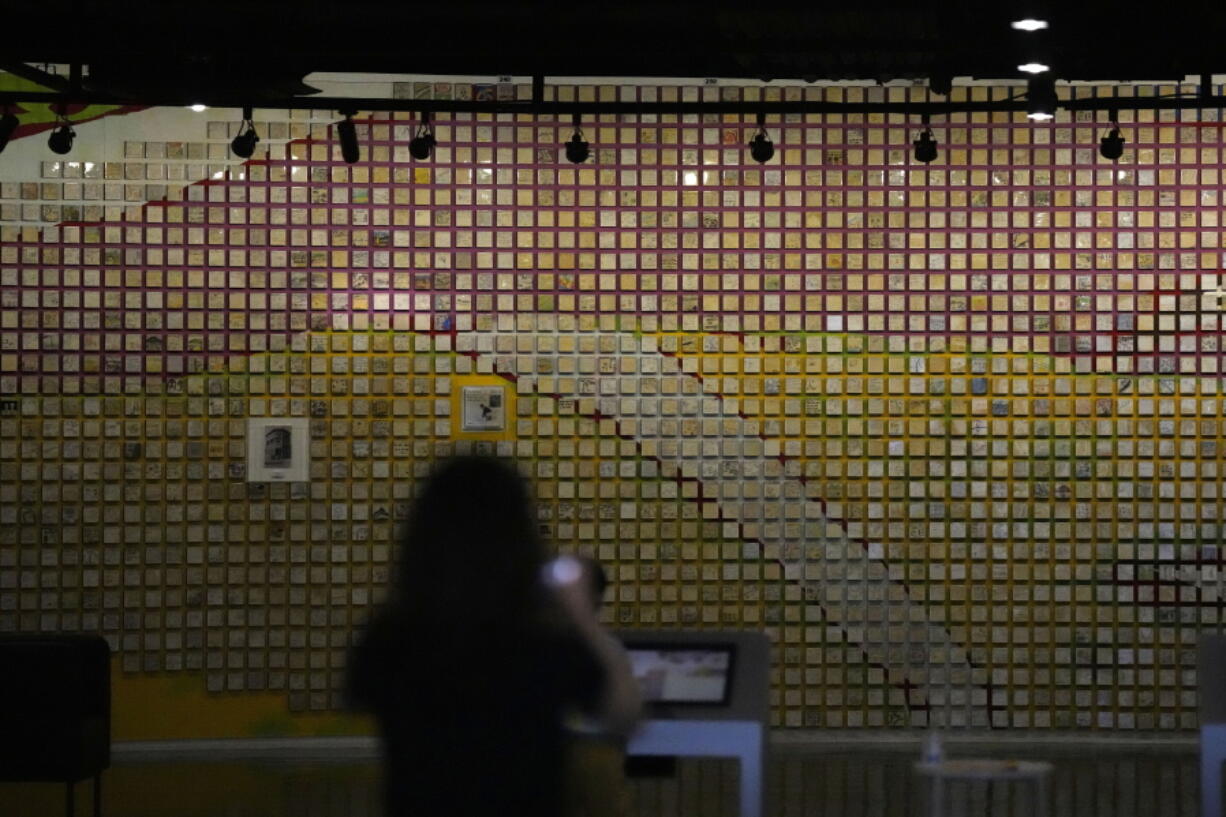 A visitor takes a photo of a wall displayed with messages and painting for families separated at the exhibition hall of the unification observatory in Paju, South Korea, Thursday, Sept. 8, 2022. South Korea's new government on Thursday proposed a meeting with North Korea to resume reunions of families separated since the 1950-53 Korean War, despite long-strained ties between the rivals over the North's nuclear weapons program.