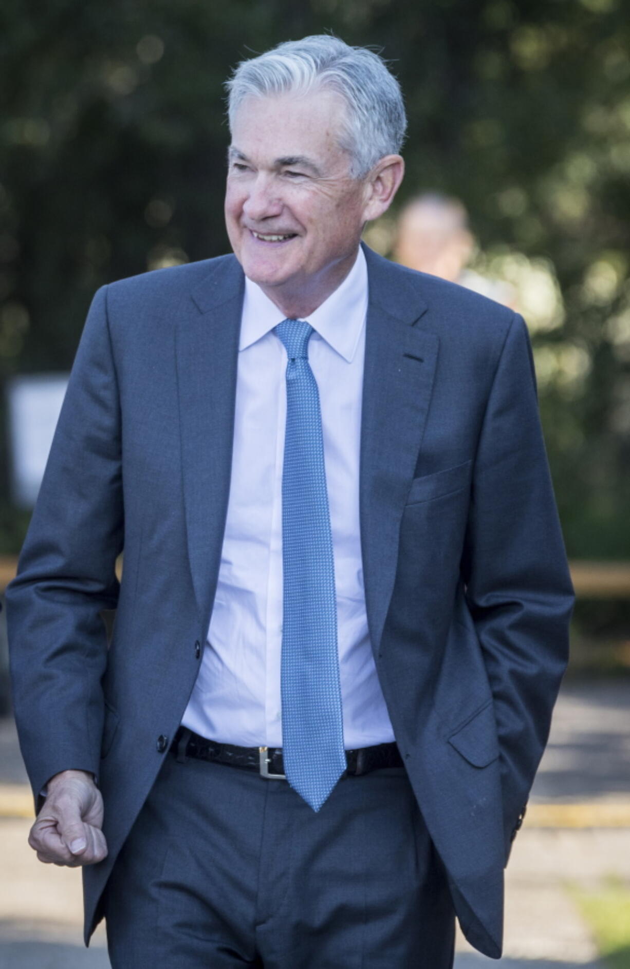 Federal Reserve Chair Jerome Powell smiles and walks after his speech at the central bank's annual symposium at Jackson Lake Lodge in Grand Teton National Park Friday, Aug. 26, 2022. in Moran, Wyo.