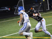 La Center's Levi Giles (left) runs past Kalama's Kaden Stariha for a touchdown during the Wildats' 49-24 win over Kalama on Thursday, Sept. 15, 2022.