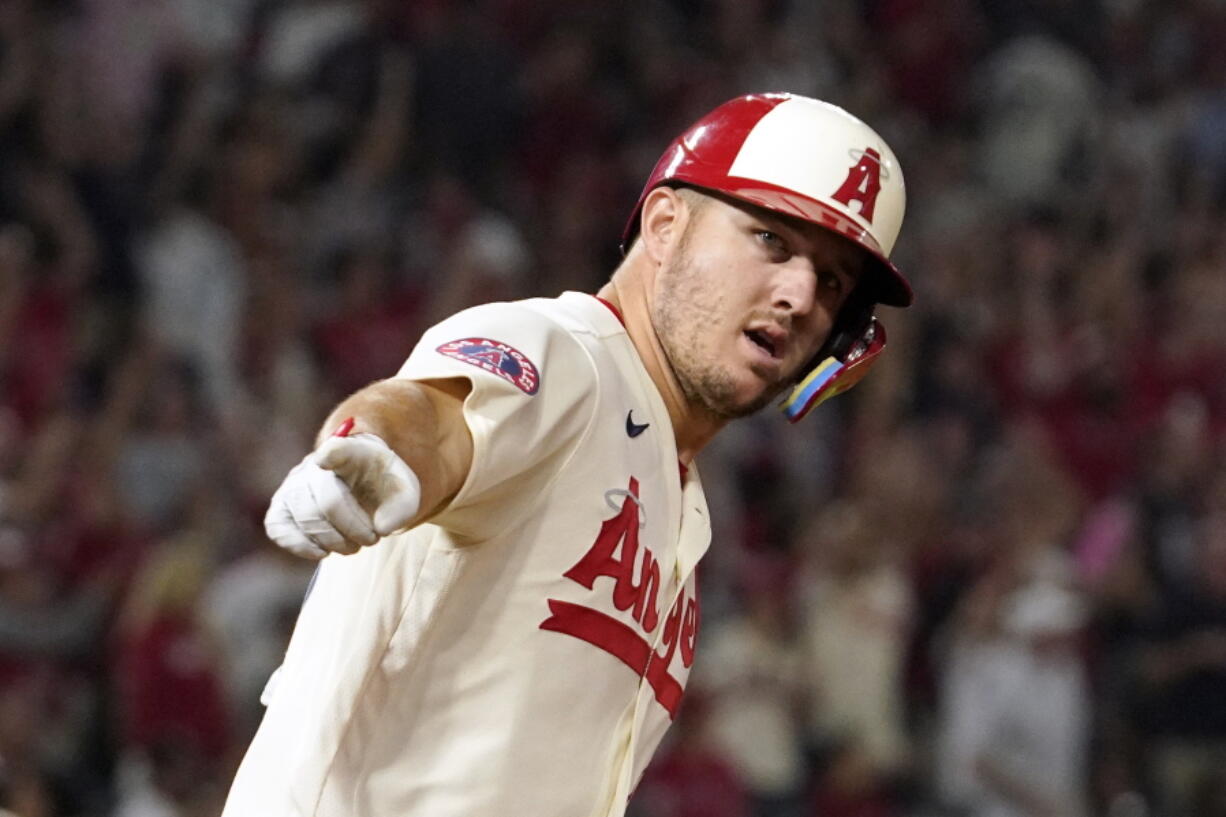 Los Angeles Angels' Mike Trout gestures as he rounds first after hitting a solo home run during the fifth inning of a baseball game against the Seattle Mariners Friday, Sept. 16, 2022, in Anaheim, Calif. (AP Photo/Mark J.