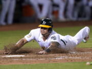 Oakland Athletics' Jordan Diaz scores against the Seattle Mariners during the seventh inning of a baseball game in Oakland, Calif., Wednesday, Sept. 21, 2022.