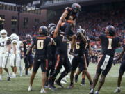 Oregon State wide receiver Anthony Gould is lifted by offensive lineman Jake Levengood after scoring a touchdown against Montana State during the first half of an NCAA college football game in Portland, Ore., Saturday, Sept. 17, 2022.