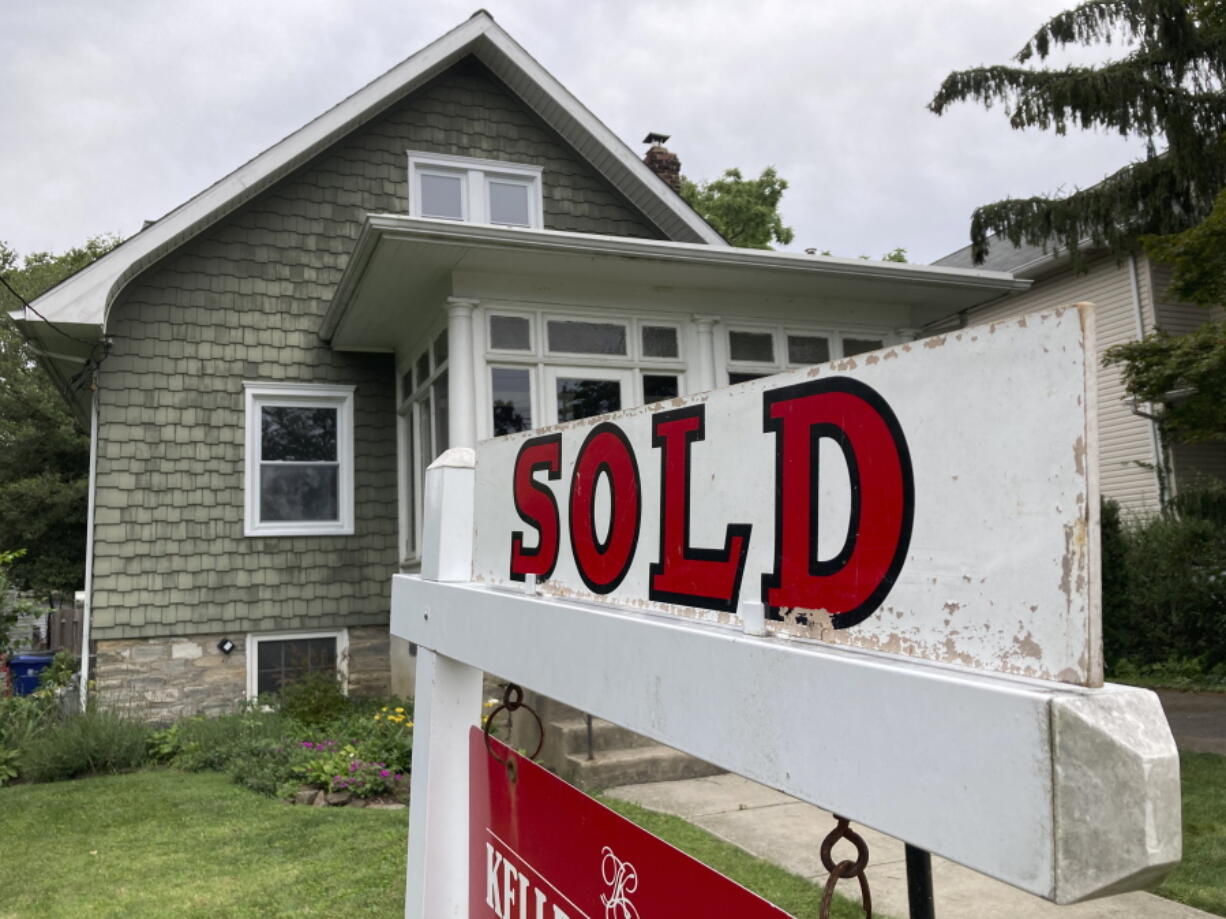 FILE - A "sold" is posted outside a single family home in a residential neighborhood, in Glenside, Pa., Wednesday, Aug. 4, 2021. Average long-term U.S. mortgage rates jumped again this week, Thursday, Sept. 8, 2022,  to their highest level in almost 14 years, certain to keep even more potential buyers out of a housing market that's cooled considerably since the Federal Reserve began jacking up its benchmark borrowing rate.