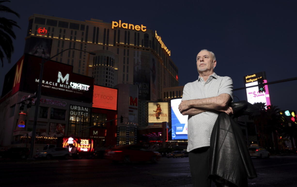 Jeff German, host of "Mobbed Up," poses with Planet Hollywood, formerly the Aladdin, in the background on the Strip in Las Vegas, Wednesday, June 2, 2021. Authorities say German, a Las Vegas investigative reporter has been stabbed to death outside his home and police are searching for a suspect. The Las Vegas Review-Journal says officers found journalist German dead with stab wounds around 10:30 a.m. Saturday, Sept. 3, 2022, after authorities received a 911 call. (K.M.