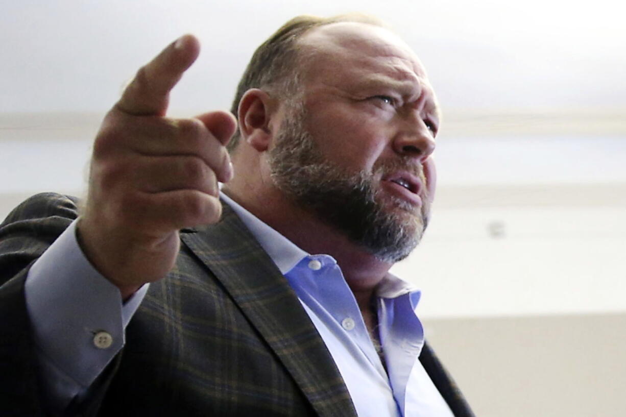 FILE - Alex Jones talks to media during a midday break in his trial at the Travis County Courthouse in Austin, Texas, on July 26, 2022. A six-member jury with several alternates in Connecticut will begin hearing evidence, Tuesday, Sept. 13, 2022, on how much Jones should pay the families, since he already has been found liable for damages to them. The trial is expected to last about four weeks.