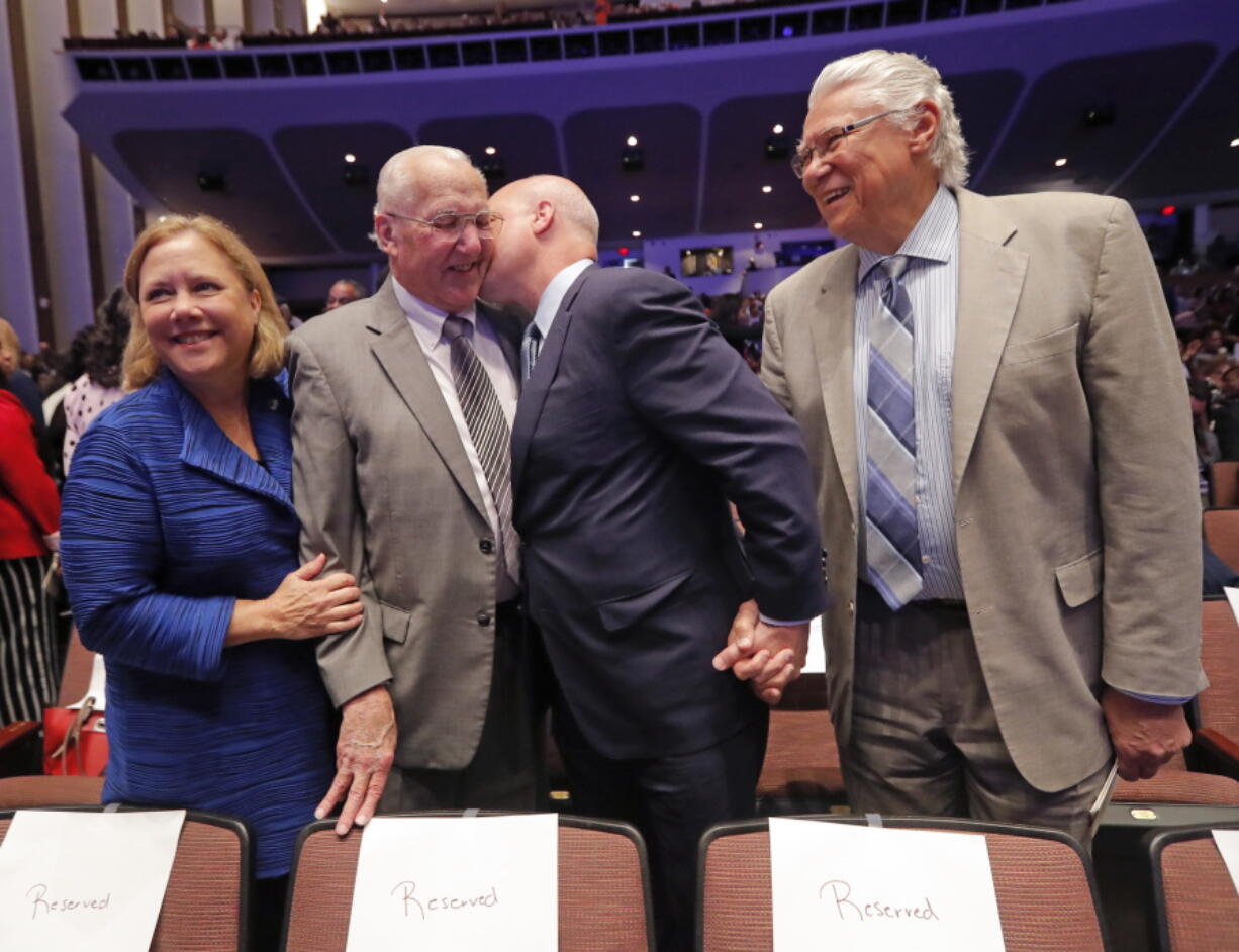 FILE - Outgoing New Orleans Mayor Mitch Landrieu kisses his father, former New Orleans Mayor Moon Landrieu, before they pose for a photo with his sister, former Sen. Mary Landrieu, D-La., and former New Orleans Mayor Sidney Barthelemy, right, before the inauguration of newly elected New Orleans Mayor Latoya Cantrell in New Orleans, Monday, May 7, 2018. Moon Landrieu, the patriarch of a Louisiana political family who was a lonely voice for civil rights until the tide turned in the 1960s, has died at age 92. A family friend said Landrieu died Monday, Sept. 5, 2022.