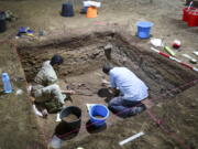 Dr. Tim Maloney and Andika Priyatno work at the site in a cave March 2, 2020, in East Kalimantan, Borneo, Indonesia. The remains, which have been dated to 31,000 years old, mark the oldest evidence for amputation yet discovered.