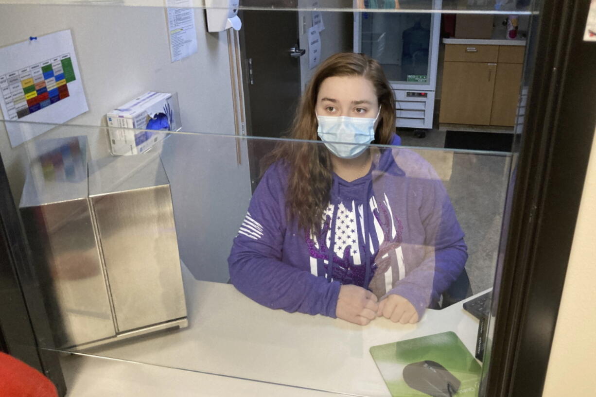 FILE--Vanessa Caudel, a nurse, sits at her work station in the Great Circle treatment center  on Feb. 24, 2022, in Salem, Ore., where she provides doses of methadone, which can relieve the "dope sick" symptoms a person in opioid withdrawal experiences. Almost two years after Oregonians voted to decriminalize drugs and dedicate hundreds of millions of dollars to treatment services, the pioneering effort has been struggling to show progress.