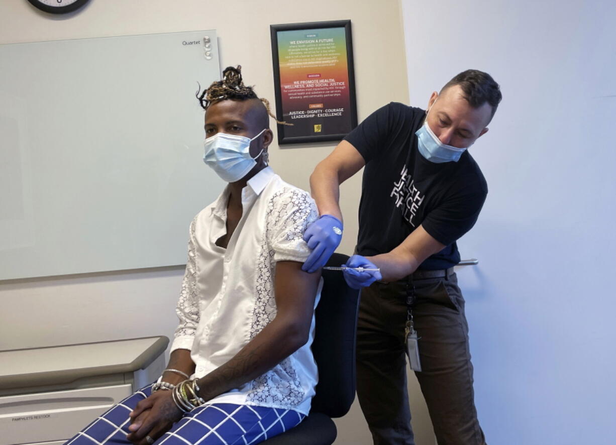 In this photo provided by the San Francisco AIDS Foundation, a person receives the Monkeypox vaccine at the San Francisco AIDS Foundation Monkeypox vaccine clinic in San Francisco. Two biopharmaceutical companies will give $5 million and $500,000, respectively, to nonprofit organizations in the United States and abroad that are responding to the growing monkeypox outbreak.