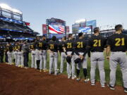 Members of the Pittsburgh Pirates, wearing No. 21 for Roberto Clemente, stand for the national anthem before a baseball game against the New York Mets on Thursday, Sept. 15, 2022, in New York.