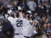 New York Yankees' Aaron Judge celebrates with Josh Donaldson (28) after hitting his 60th home run of the season, during the ninth inning of the team's baseball game against the Pittsburgh Pirates on Tuesday, Sept. 20, 2022, in New York.