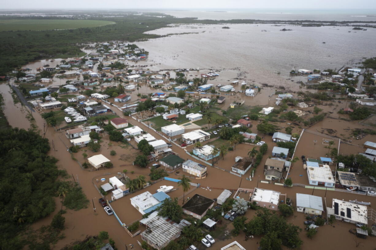 Homes are flooded on Salinas Beach after the passing of Hurricane Fiona in Salinas, Puerto Rico, Monday, Sept. 19, 2022.