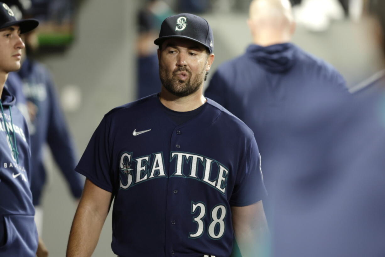 Seattle Mariners starting pitcher Robbie Raywals walks through the dugout after he was pulled from the game during the sixth inning of a baseball game against the Texas Rangers, Tuesday, Sept. 27, 2022, in Seattle.