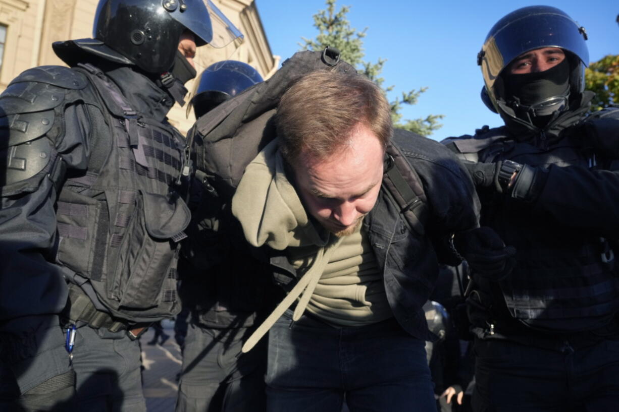 Russian policemen detain a demonstrator protesting against mobilization in St. Petersburg, Russia, Saturday, Sept. 24, 2022.