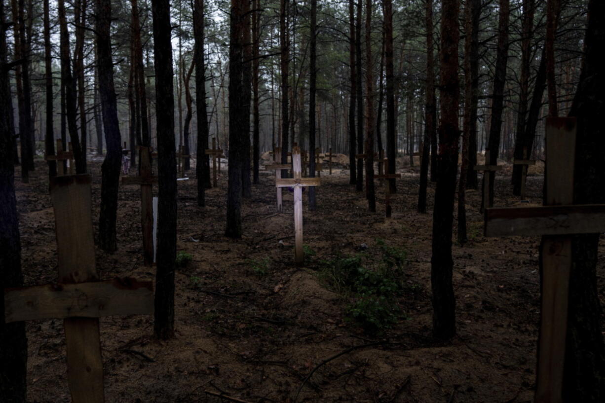 A view of unidentified graves of civilians and Ukrainian soldiers in a cemetery in the recently retaken area of Izium, Ukraine, Thursday, Sept. 15, 2022 who had been killed by Russian forces near the beginning of the war. A mass grave of Ukrainian soldiers and unknown buried civilians was found in the forest of recently recaptured city of Izium.