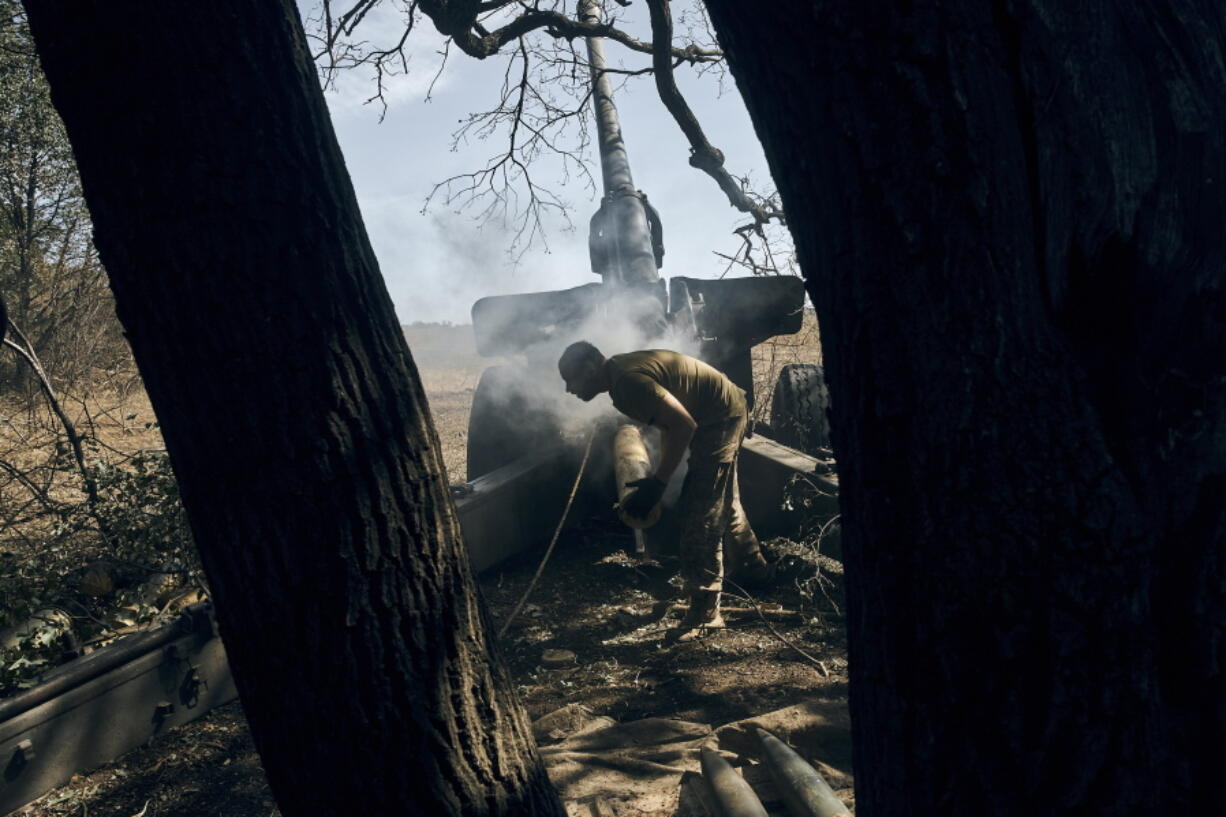 A Ukrainian soldier fires on the front line in the Donetsk region, eastern Ukraine, Sat. Sept. 3, 2022.