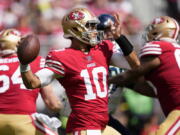 San Francisco 49ers quarterback Jimmy Garoppolo (10) passes against the Seattle Seahawks during the first half of an NFL football game in Santa Clara, Calif., Sunday, Sept. 18, 2022.