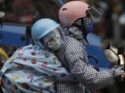 People ride scooter in the rain ahead of the approaching Typhoon Muifa in Taipei, Taiwan, Monday, Sept. 12, 2022.