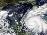 This Sept. 26, 2022, satellite image released by NASA shows Hurricane Ian growing stronger as it barreled toward Cuba. Ian was forecast to hit the western tip of Cuba as a major hurricane and then become an even stronger Category 4 with top winds of 140 mph (225 km/h) over warm Gulf of Mexico waters before striking Florida.