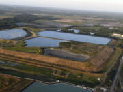 FILE - This aerial photo taken from an airplane shows a reservoir near the old Piney Point phosphate mine on April 3, 2021, in Bradenton, Fla. The polluted leftovers of Florida's phosphate fertilizer mining industry, more than 1 billion tons in "stacks" that resemble enormous ponds, are at risk for leaks or other contamination triggered by Hurricane Ian, said environmental groups Tuesday, Sept. 27, 2022.