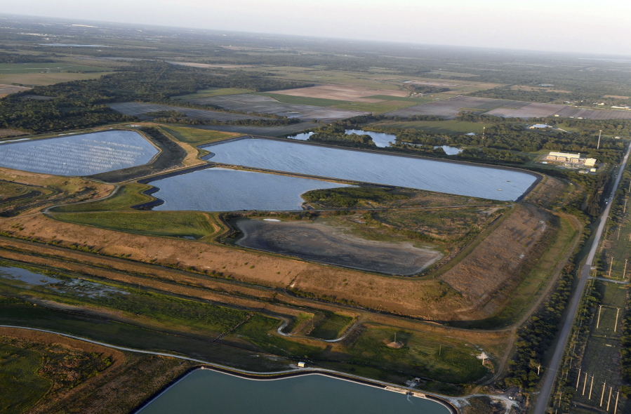 FILE - This aerial photo taken from an airplane shows a reservoir near the old Piney Point phosphate mine on April 3, 2021, in Bradenton, Fla. The polluted leftovers of Florida's phosphate fertilizer mining industry, more than 1 billion tons in "stacks" that resemble enormous ponds, are at risk for leaks or other contamination triggered by Hurricane Ian, said environmental groups Tuesday, Sept. 27, 2022.