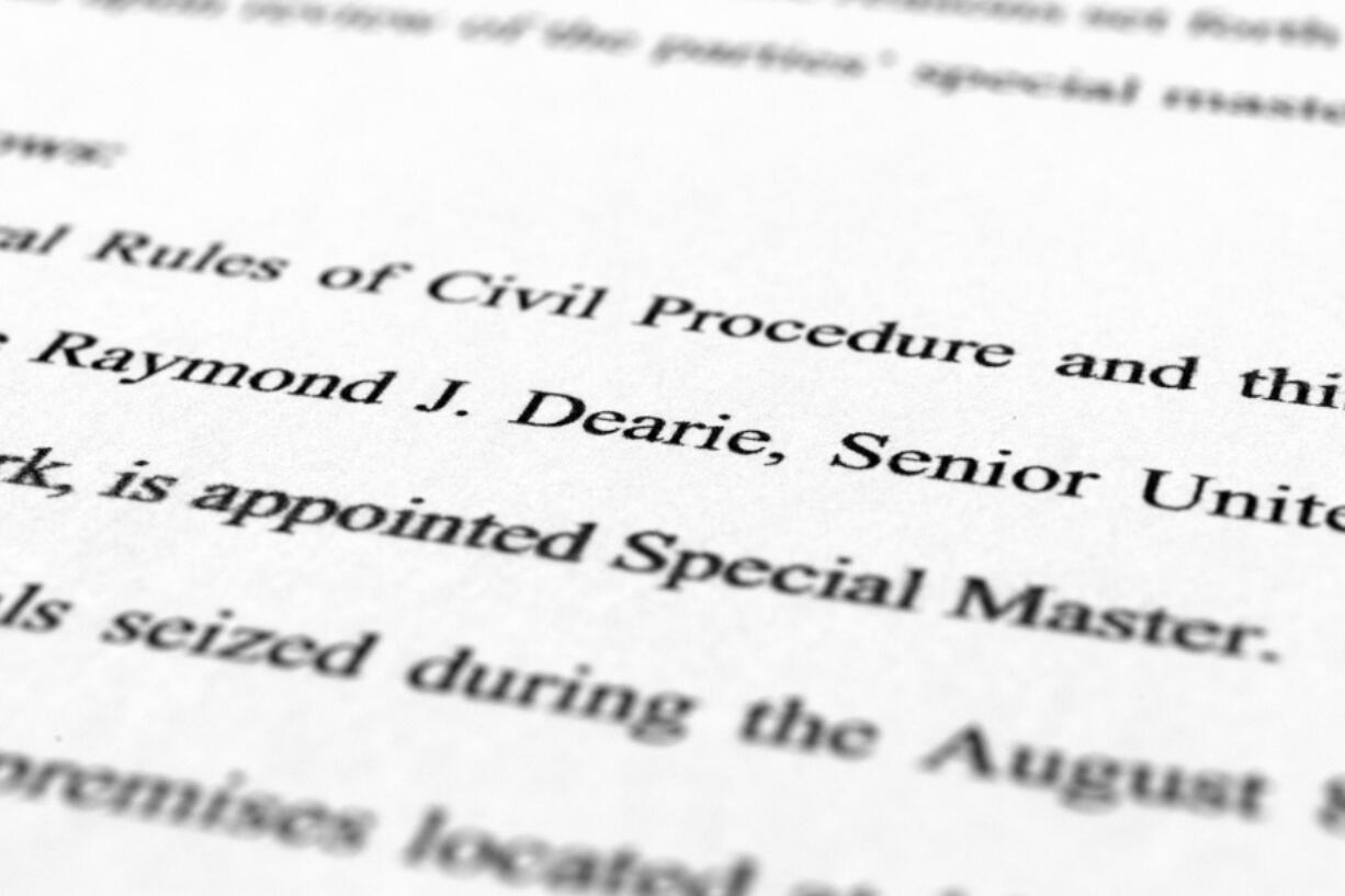 A page from the order by U.S. District Judge Aileen Cannon naming Raymond Dearie as special master to serve as an independent arbiter and to review records seized during the FBI search of former President Donald Trump's Mar-a-Lago estate, is photographed Thursday, Sept. 15, 2022.