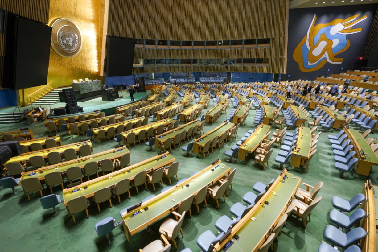 Visitors to the United Nations headquarters take photos at the General Assembly speaker's podium ahead of the General Assembly, Friday, Sept. 16, 2022.