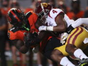 Oregon State running back Jam Griffin is brought down by Southern California defensive back Max Williams during the first half of an NCAA college football game Saturday, Sept. 24, 2022, in Corvallis, Ore.