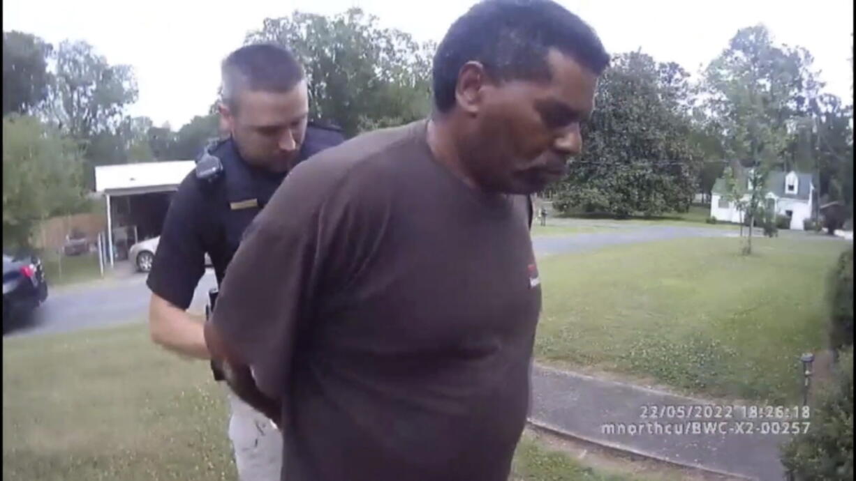 This image captured from bodycam video released by the Childersburg (Ala.) Police Department and provided by attorney Harry Daniels shows Michael Jennings, right, in custody in Childersburg, Ala., on Sunday, May 22, 2022. Jennings was helping out a friend by watering flowers when officers showed up and placed him under arrest within moments.