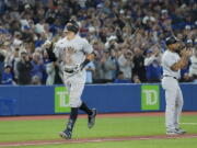 New York Yankees' Aaron Judge celebrates his 61st home run of the season, a two-run shot against the Toronto Blue Jays during the seventh inning of a baseball game Wednesday, Sept. 28, 2022, in Toronto.